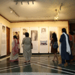 Visitors looking at the exhibition posters